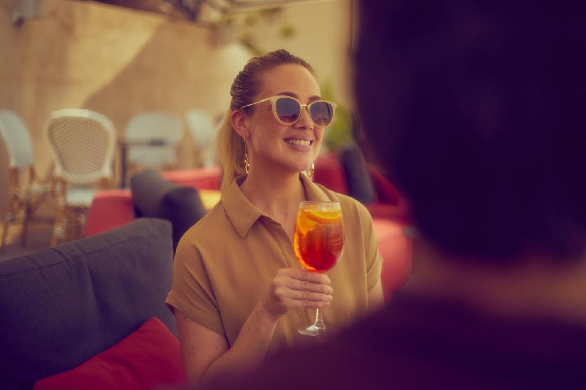Secrets Mallorca Villamil Resort & Spa - Adults Only Peguera Eksteriør bilde A woman drinking an Aperol Spritz